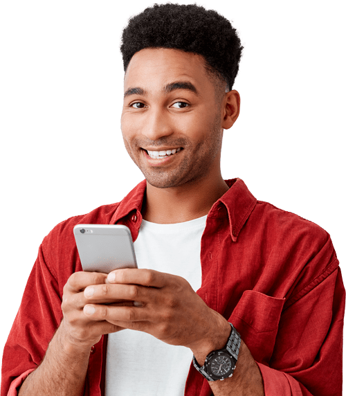 A man smiling while using his smartphone