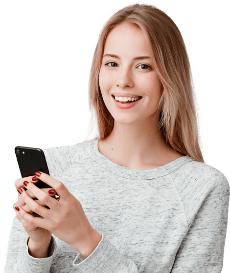 A young woman smiling while holding a cell phone